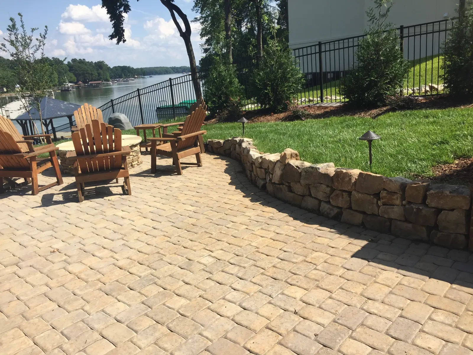 Patio and hardscape with fencing in Mooresville, NC built by Aqua Pools & Outdoor Living