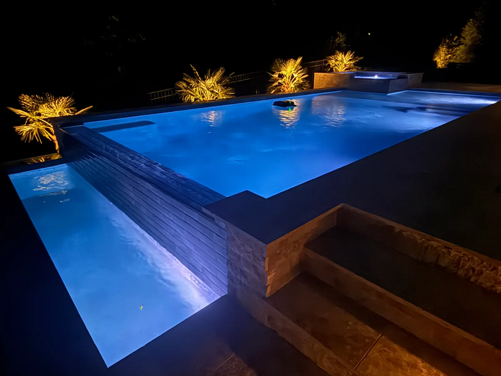 Infinity edge pool with an outdoor kitchen in Davidson, NC, view 5