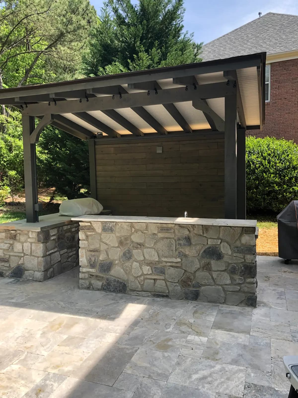 Outdoor kitchen with a covered structure in Charlotte, NC built by Aqua Pools & Outdoor Living