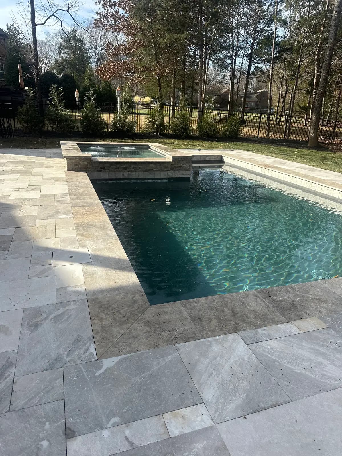 Gunite pool and spa with landscaping in Charlotte, NC built by Aqua Pools & Outdoor Living