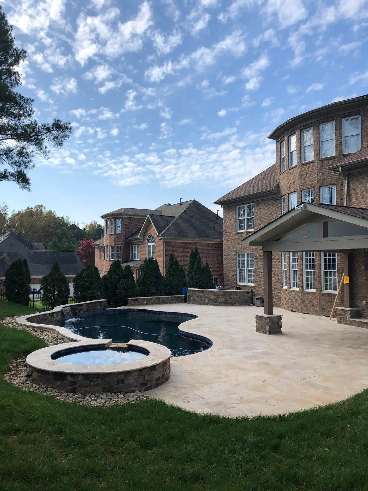 Gunite pool and spa with a covered structure in Huntersville, NC built by Aqua Pools & Outdoor Living