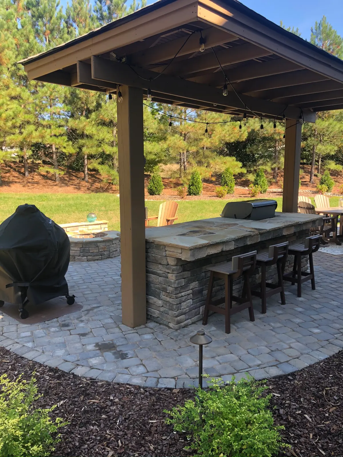 Covered outdoor room with an outdoor kitchen in Charlotte, NC built by Aqua Pools & Outdoor Living