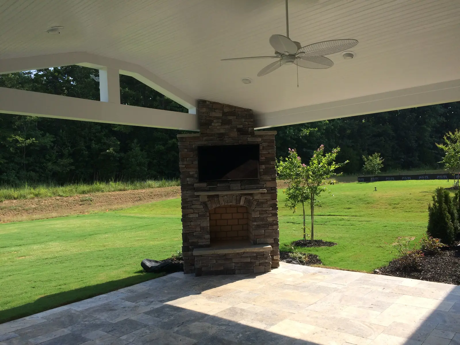 Covered outdoor room with an outdoor kitchen in Waxhaw, NC built by Aqua Pools & Outdoor Living