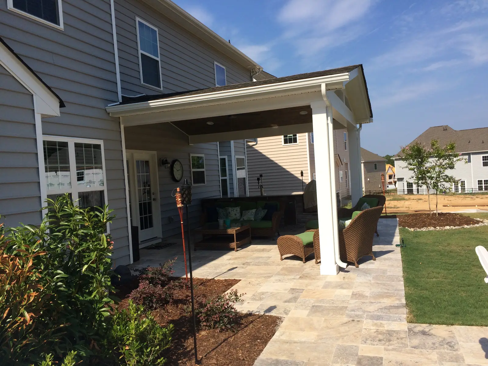 Covered outdoor room with an outdoor kitchen in Davidson, NC built by Aqua Pools & Outdoor Living