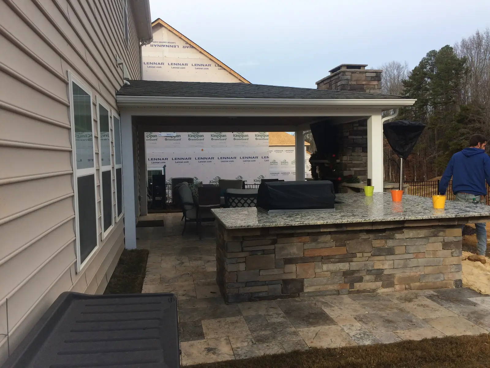 Covered outdoor room with an outdoor kitchen in Davidson, NC built by Aqua Pools & Outdoor Living