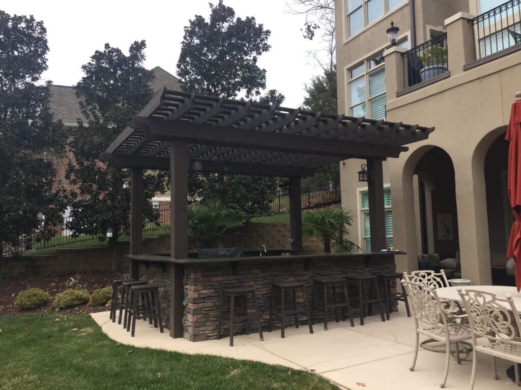 Outdoor kitchen covered by a 9' tall pergola in Charlotte NC