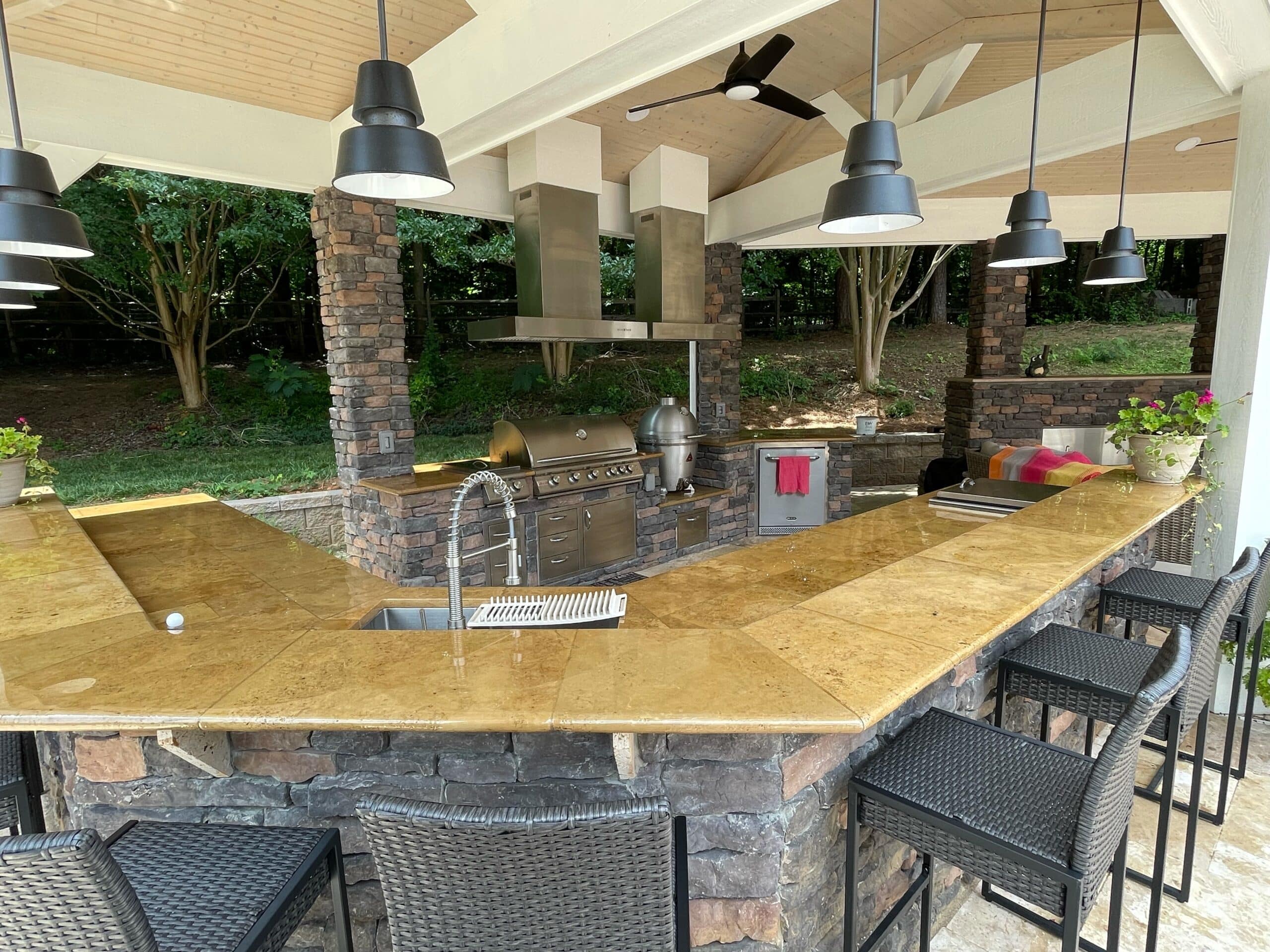 Custom outdoor kitchen with stone counters and built-in grill - Charlotte NC